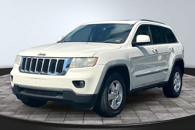 2012 Jeep Grand Cherokee Laredo in Stone White Clearcoat — front three-quarter view