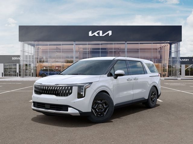 2026 Kia Carnival LXS in Snow White Pearl — front three-quarter view